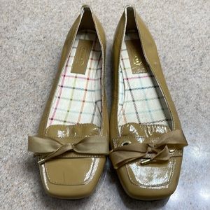 Women’s tab patent leather Coach loafers.